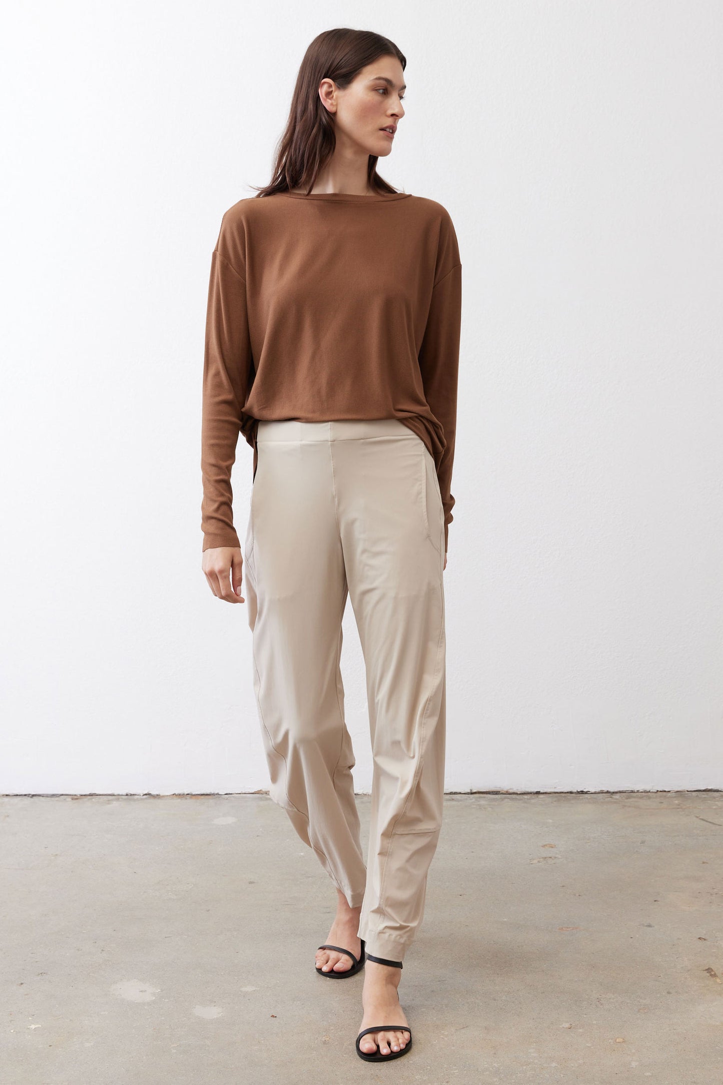 Deep brown long-sleeve top with crew neck, draped fit, front view