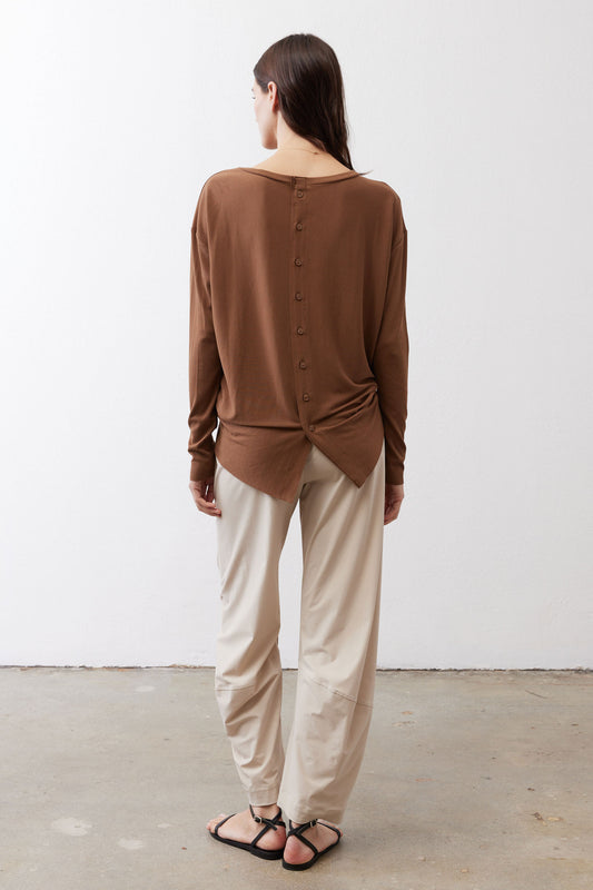 Deep oak long-sleeve top with back buttons and tied knot at back hem