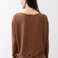 Deep brown button-back top with long sleeves and gathered tie at back hem