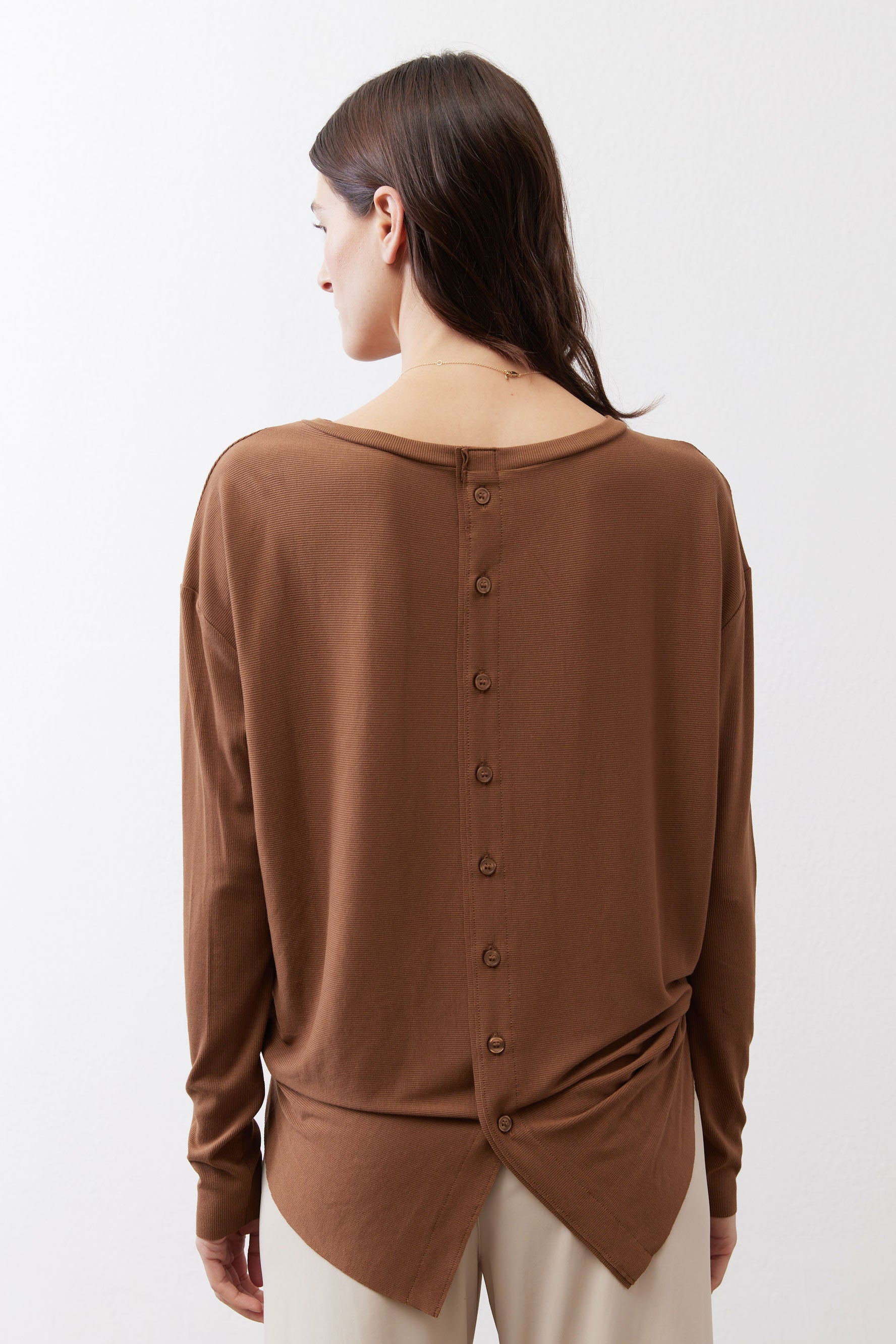 Deep brown button-back top with long sleeves and gathered tie at back hem