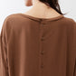Deep brown button-back top neckline close-up, long sleeves, button placket