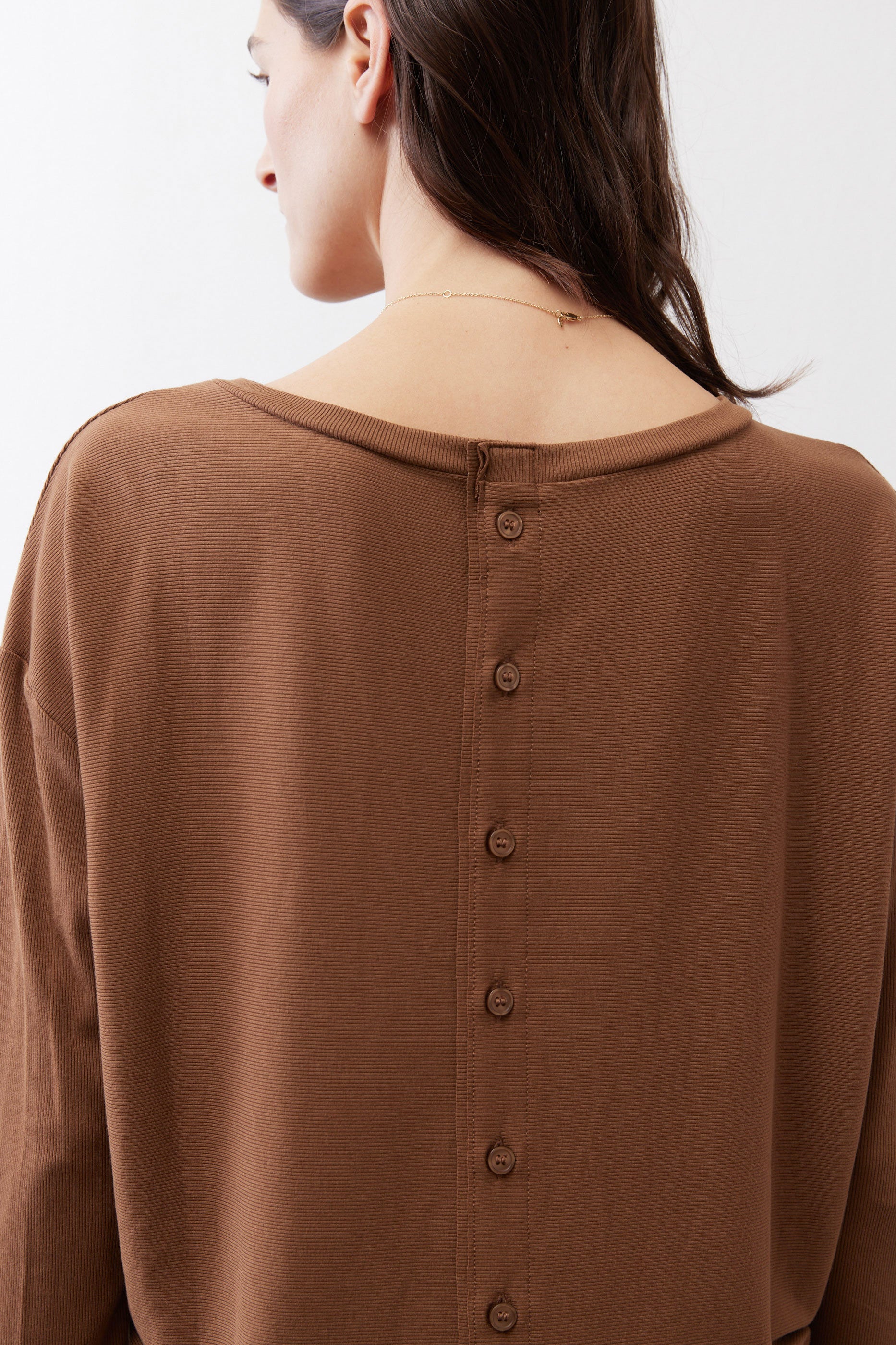 Deep brown button-back top neckline close-up, long sleeves, button placket