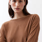 Deep brown crew-neck long-sleeve top close-up, soft drape at shoulders