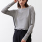 Gray melange long-sleeve crewneck top, front view with arm raised