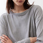 Gray melange long-sleeve crewneck top close-up of neckline and fabric