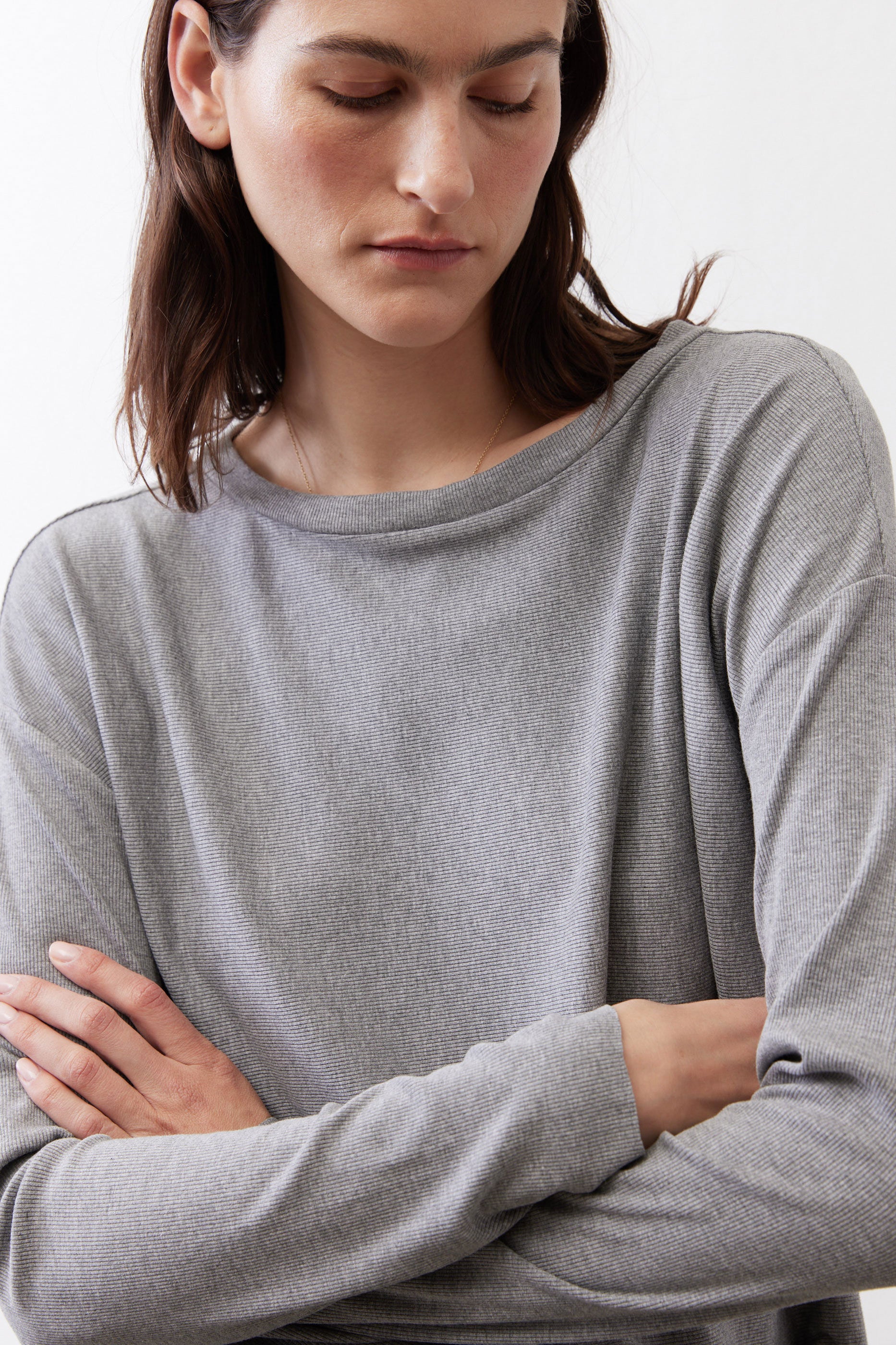 Gray melange long-sleeve crewneck top close-up of neckline and fabric