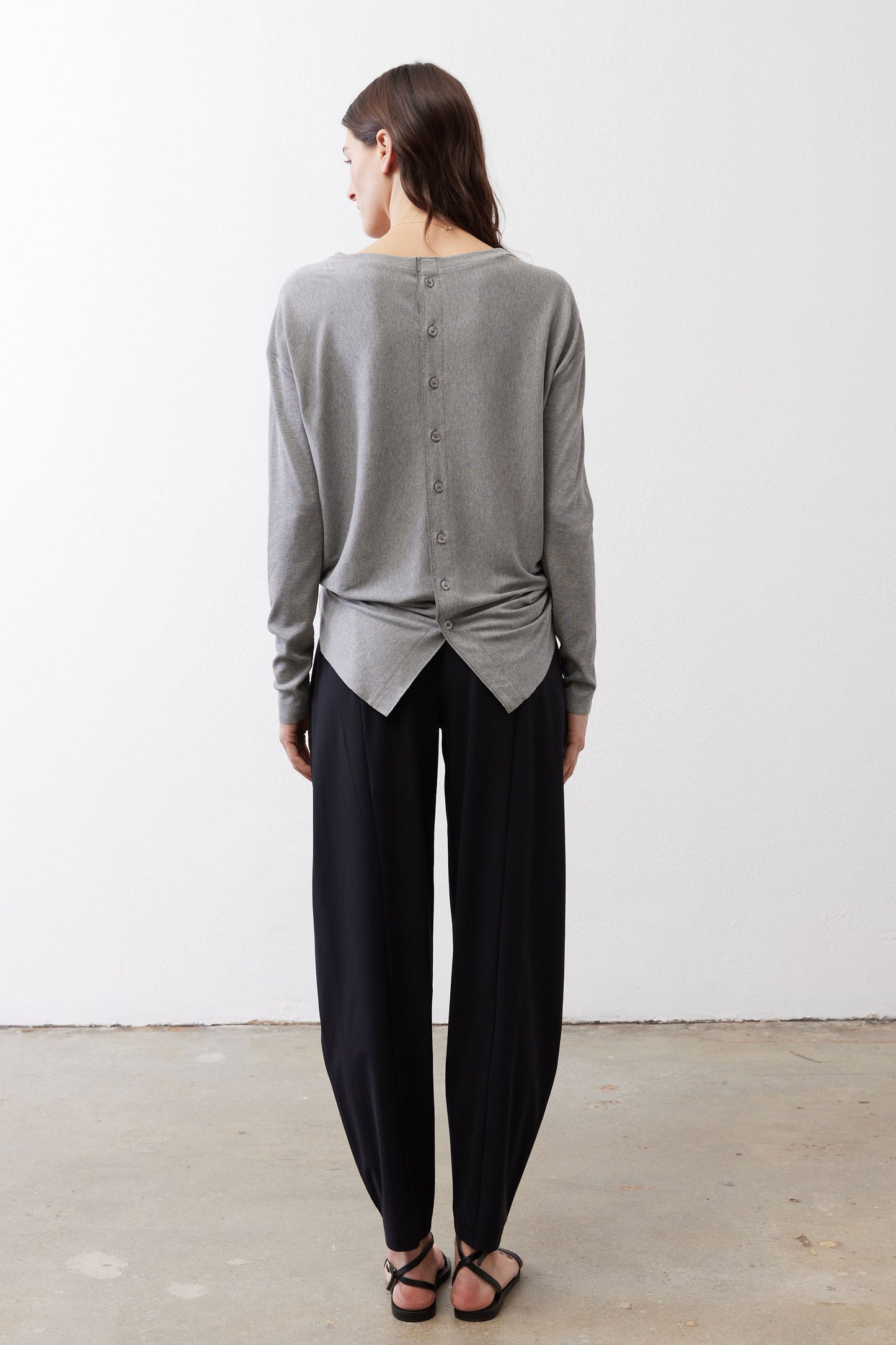 Gray melange button-back long-sleeve top with knotted back hem, back view