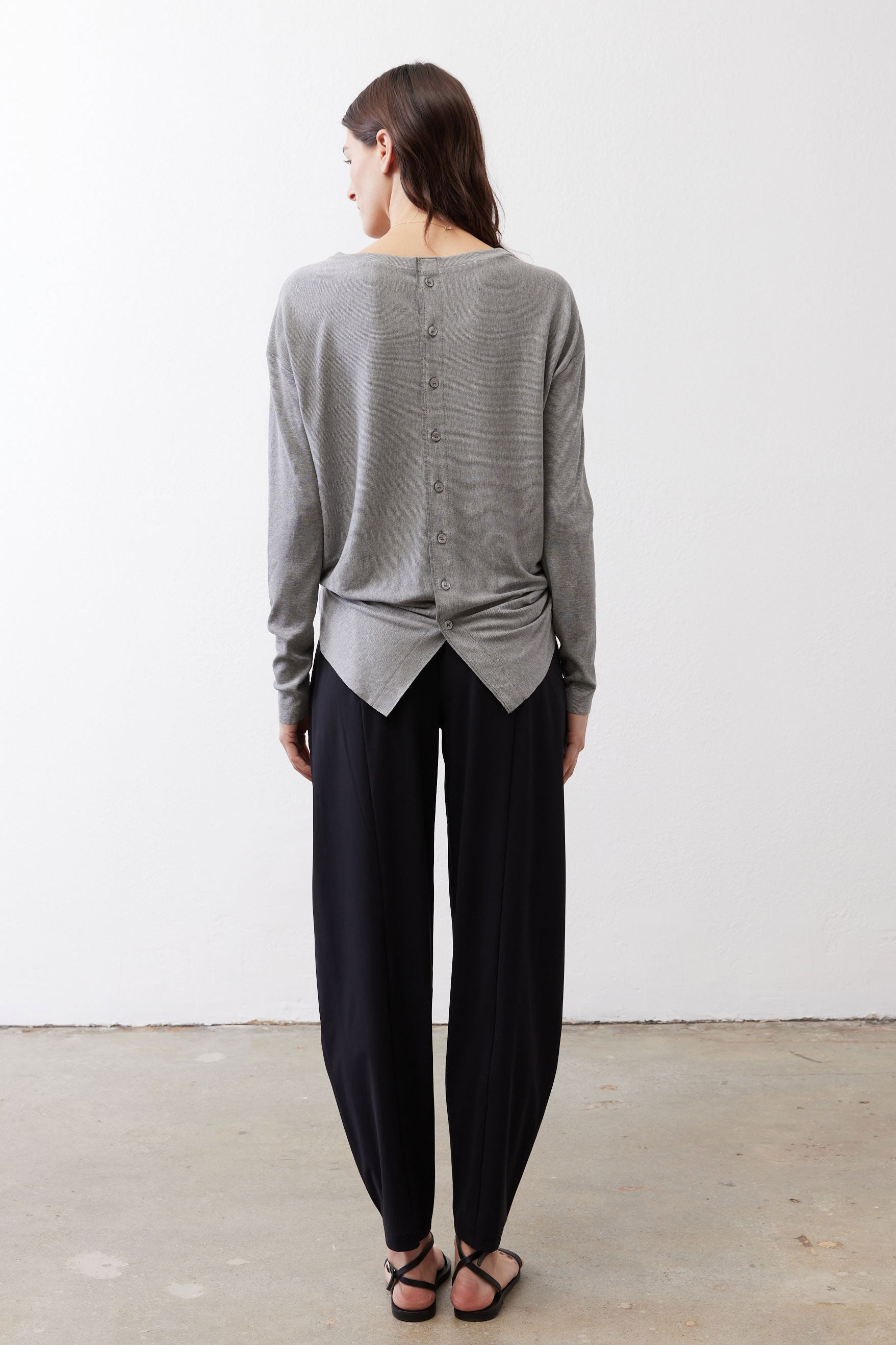 Gray melange button-back long-sleeve top with knotted back hem, back view