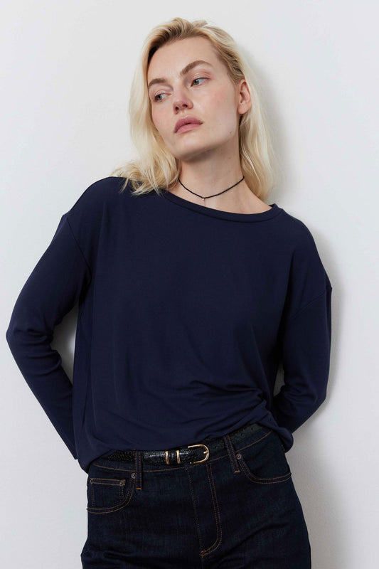 Deep navy long-sleeve top with crew neckline and twisted waist hem.
