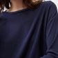 Deep navy long-sleeve top with crew neckline and smooth knit texture