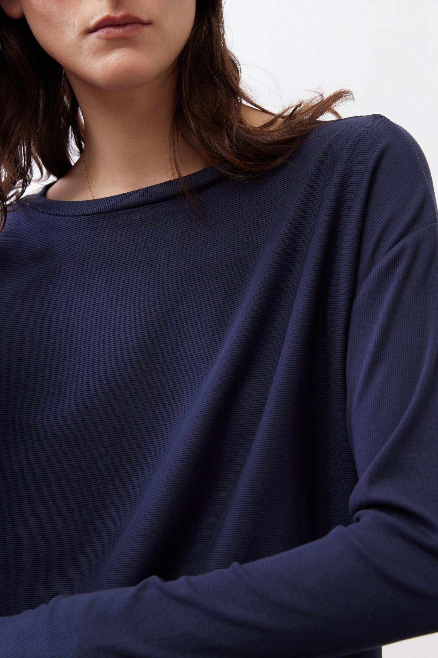 Deep navy long-sleeve top with crew neckline and smooth knit texture