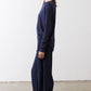 Deep navy long-sleeve top side view with tied back and relaxed drape