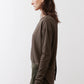 Dark olive long-sleeve top with round neck, side view