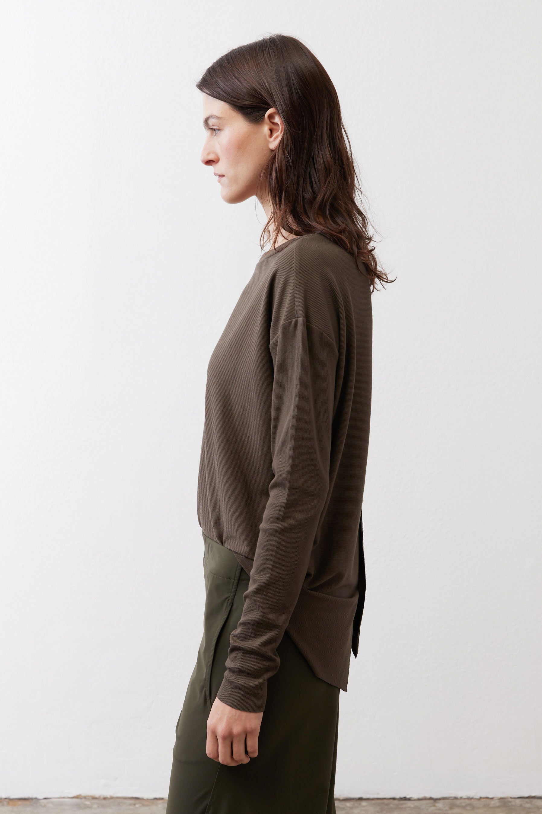 Dark olive long-sleeve top with round neck, side view