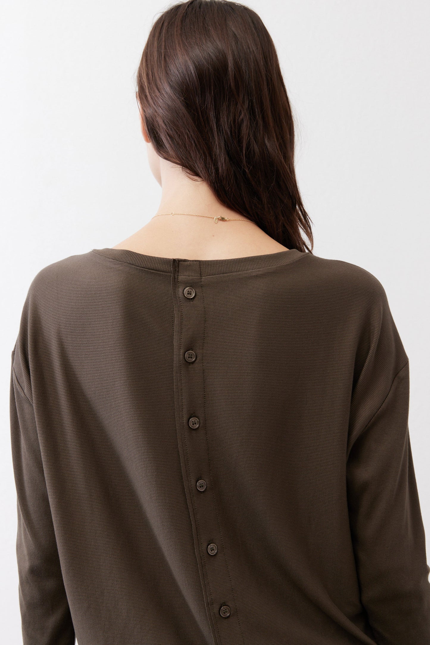Dark olive top back with vertical button placket and long sleeves