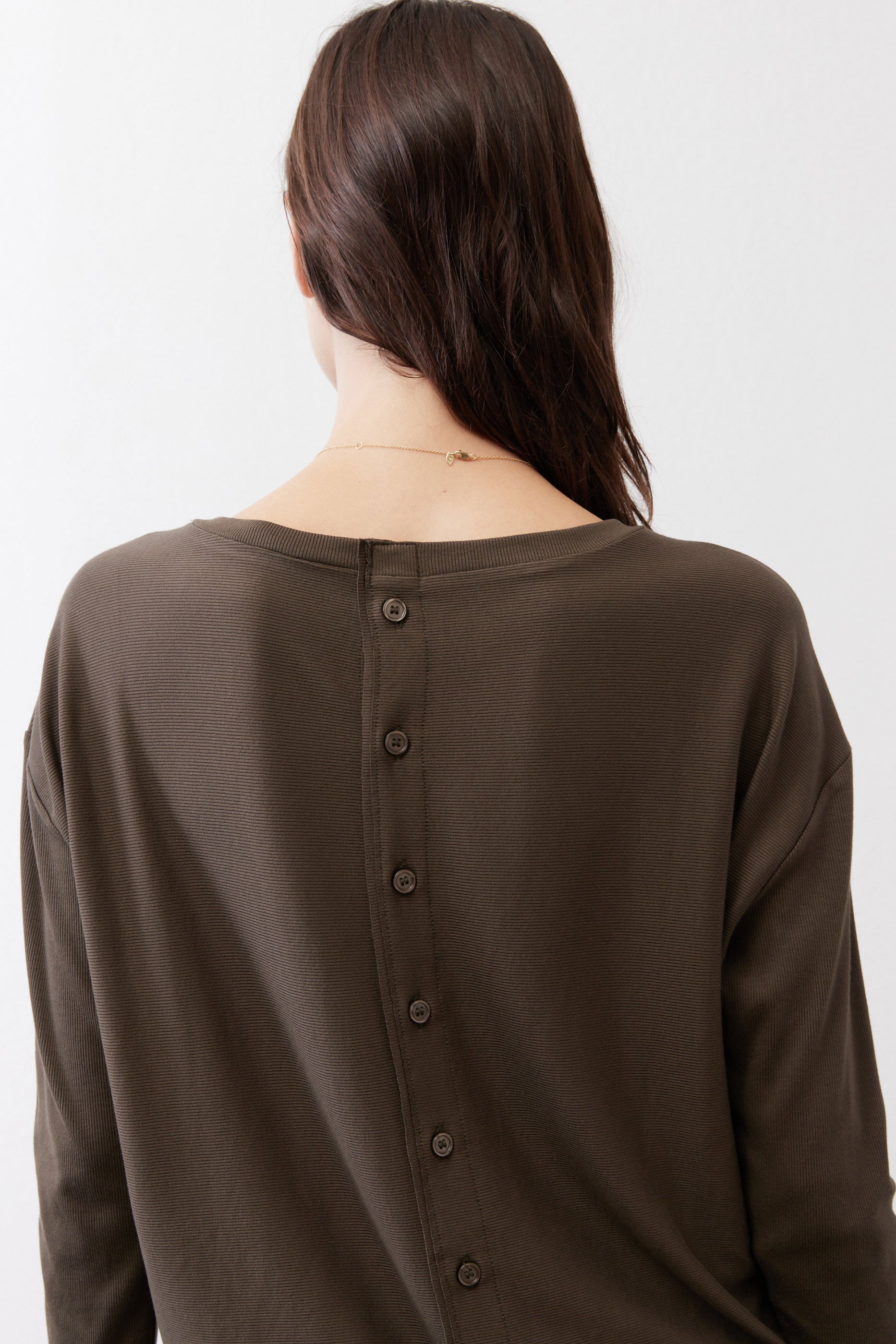 Dark olive top back with vertical button placket and long sleeves