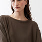 Dark olive long-sleeve top with round neckline and relaxed fit