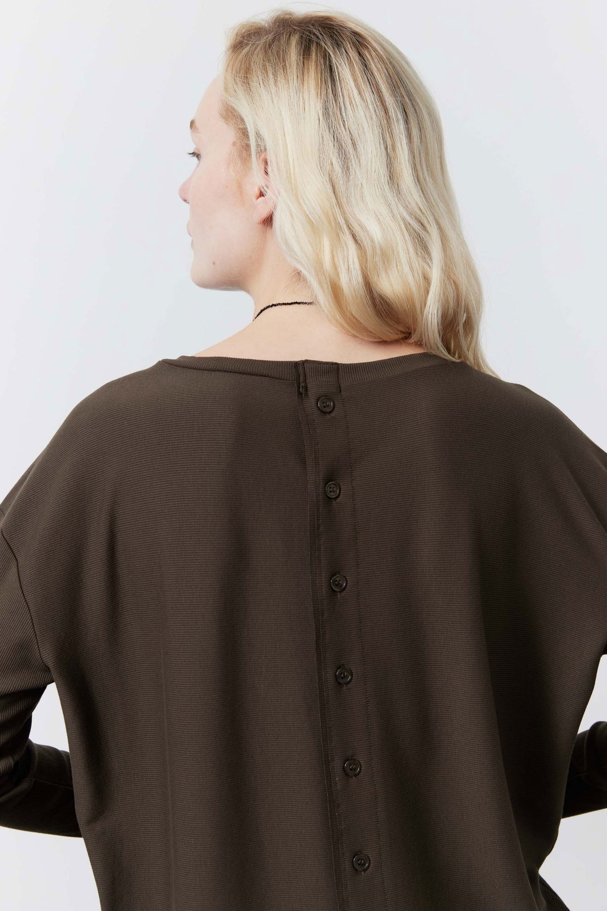 Dark taupe top back view showing vertical button placket near neckline