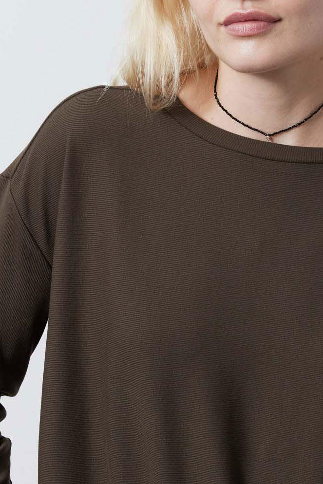 Close-up of dark taupe crewneck top with long sleeves and fine knit texture