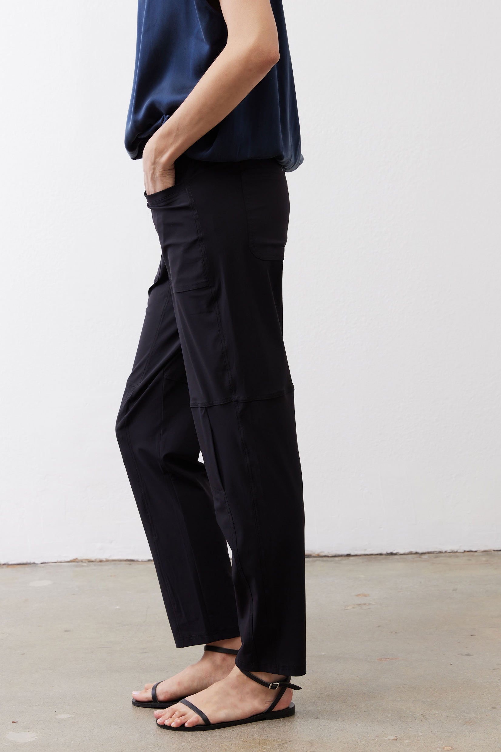Black slim pants with side cargo pockets and tapered ankle