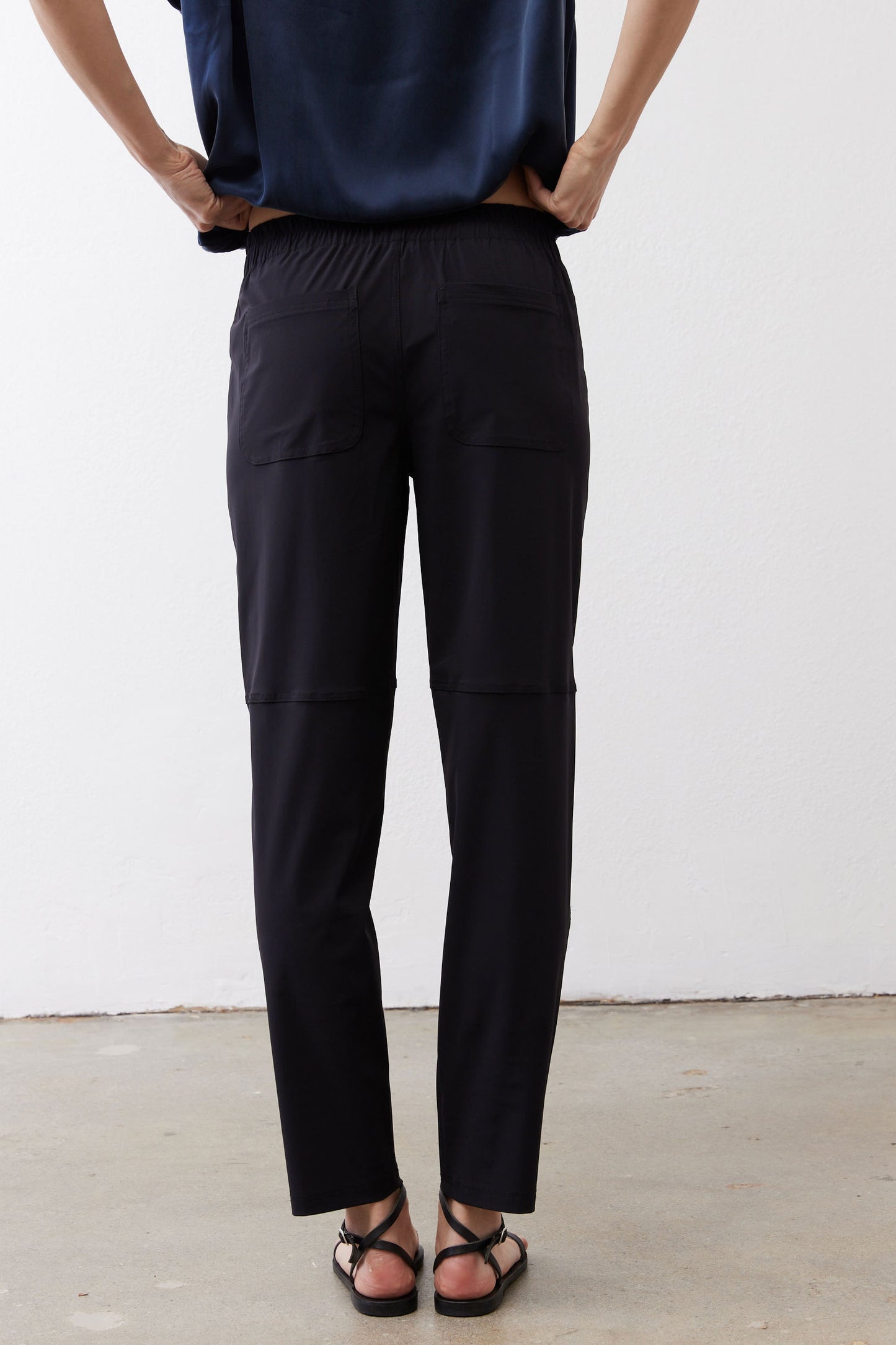Black slim pants with gathered elastic waistband and cargo pockets
