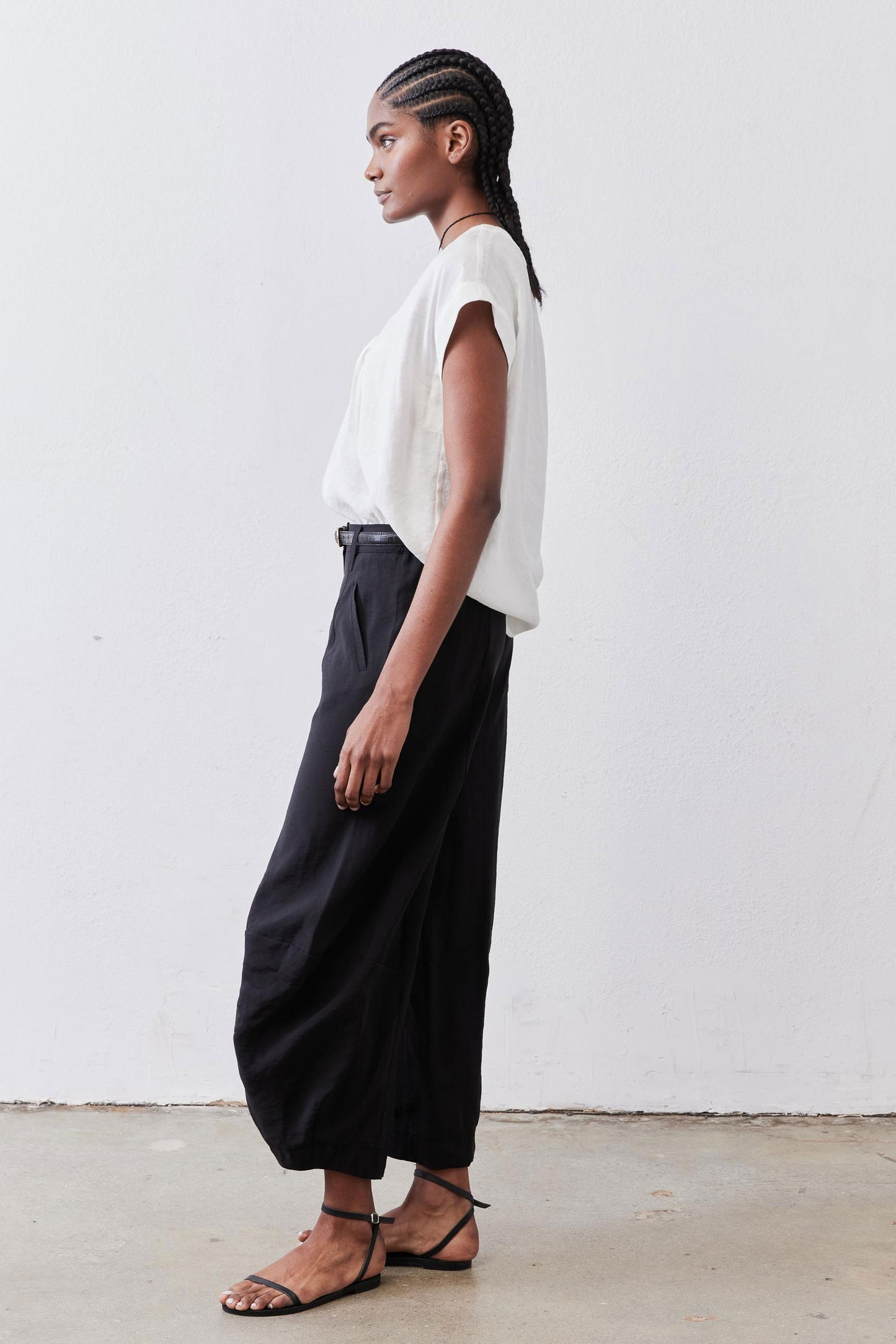 Black wide-leg pants with elastic waistband and relaxed straight legs to ankle hem