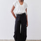 Black wide-leg pants with elastic waistband, side pockets, and ankle-length hem