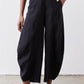 Black wide-leg pants with elastic waistband, buttoned front, and side pockets