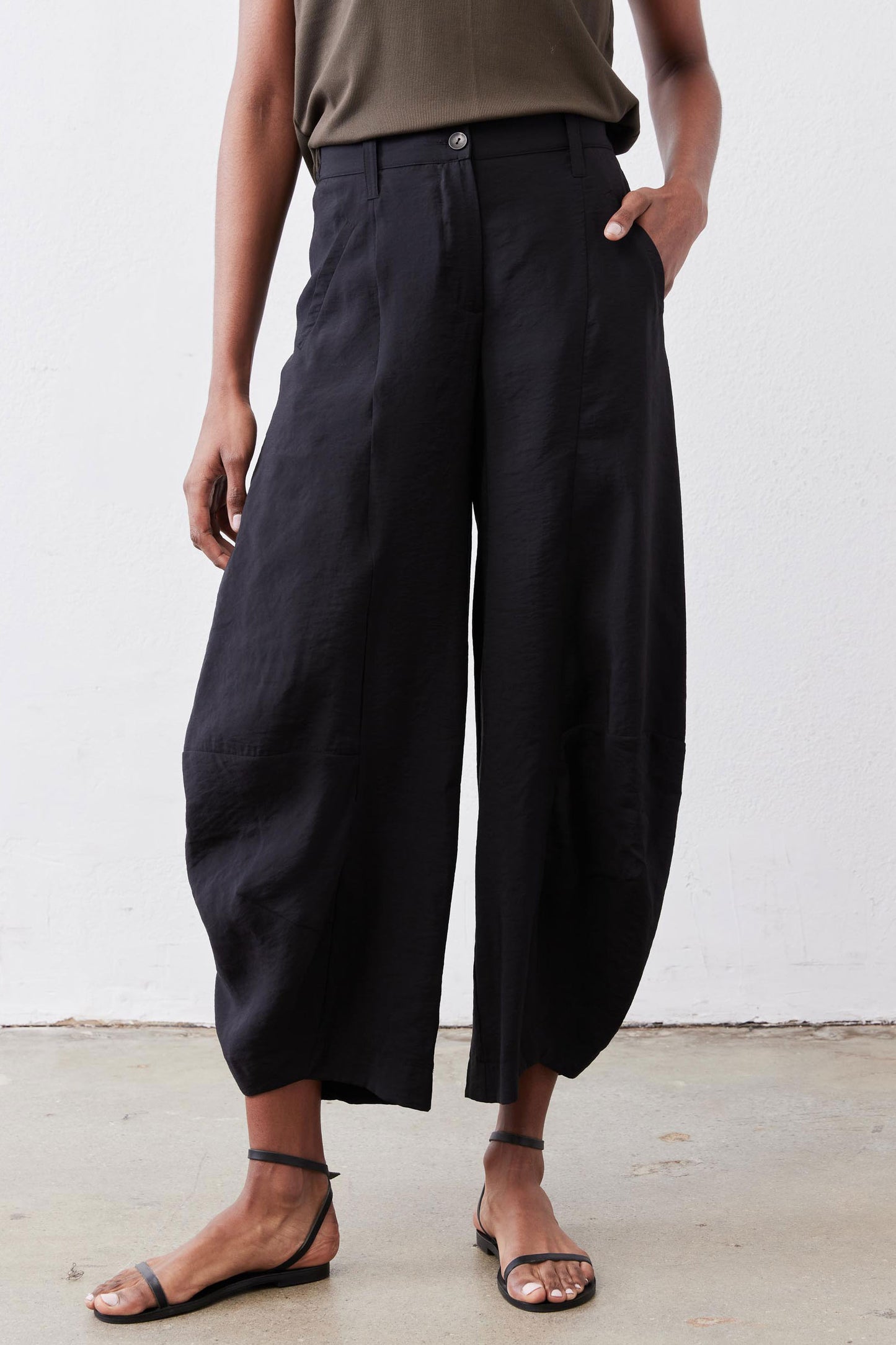 Black wide-leg pants with elastic waistband, buttoned front, and side pockets