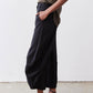 Black wide-leg pants with elastic waistband and wide cropped legs, side pocket