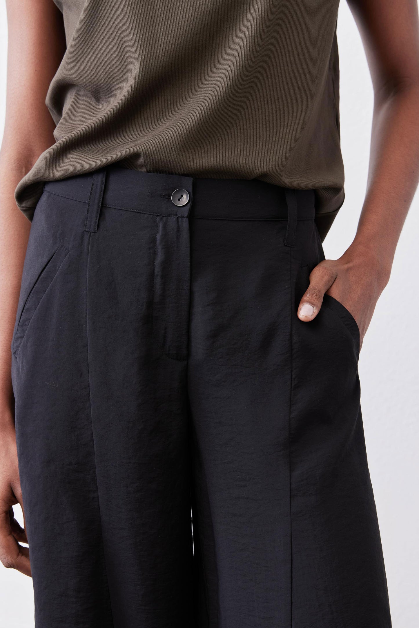 Black wide-leg pants with elastic waistband and buttoned front detail