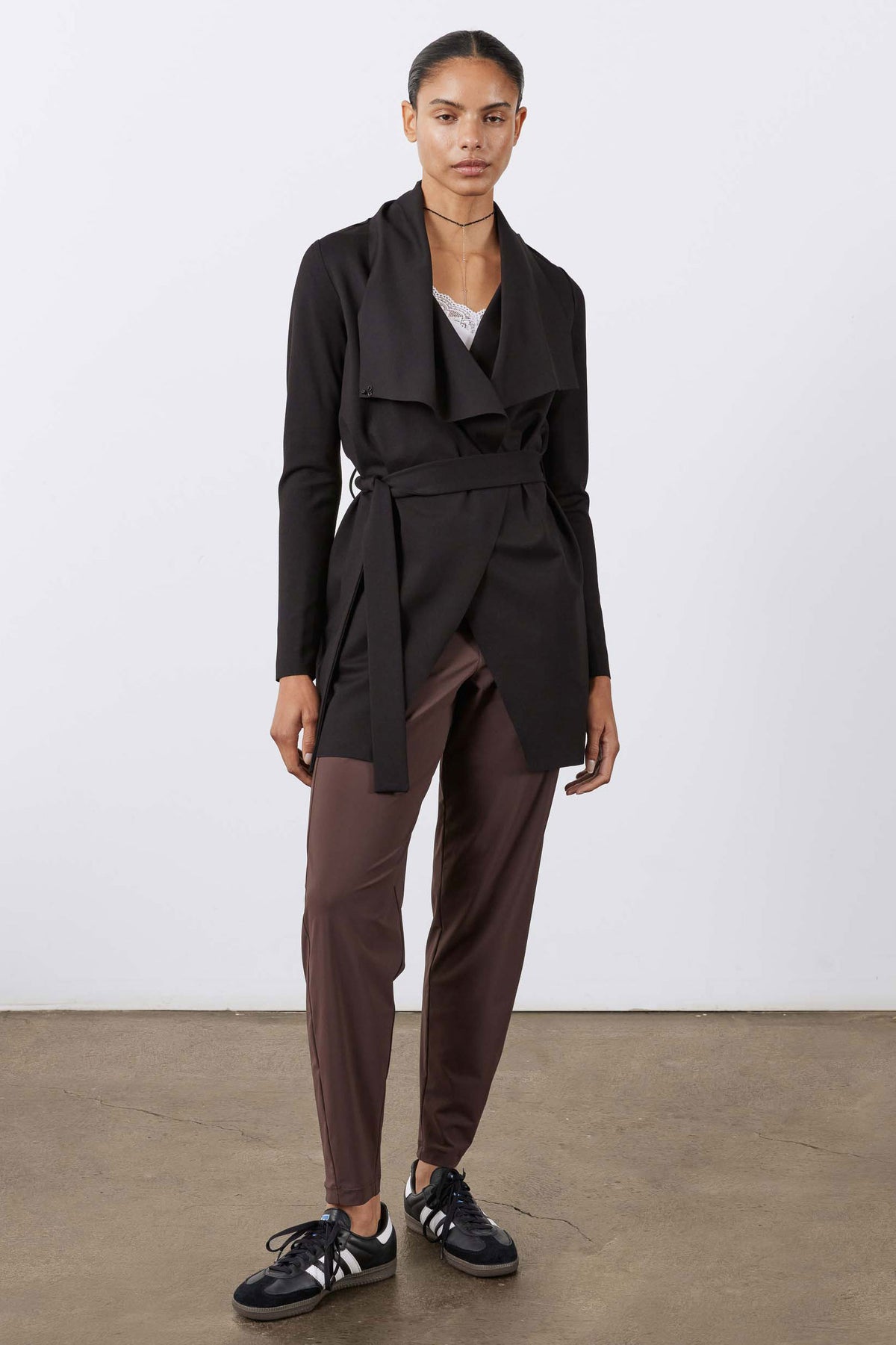 Black wrap draped jacket with waist belt tie and long sleeves, open front
