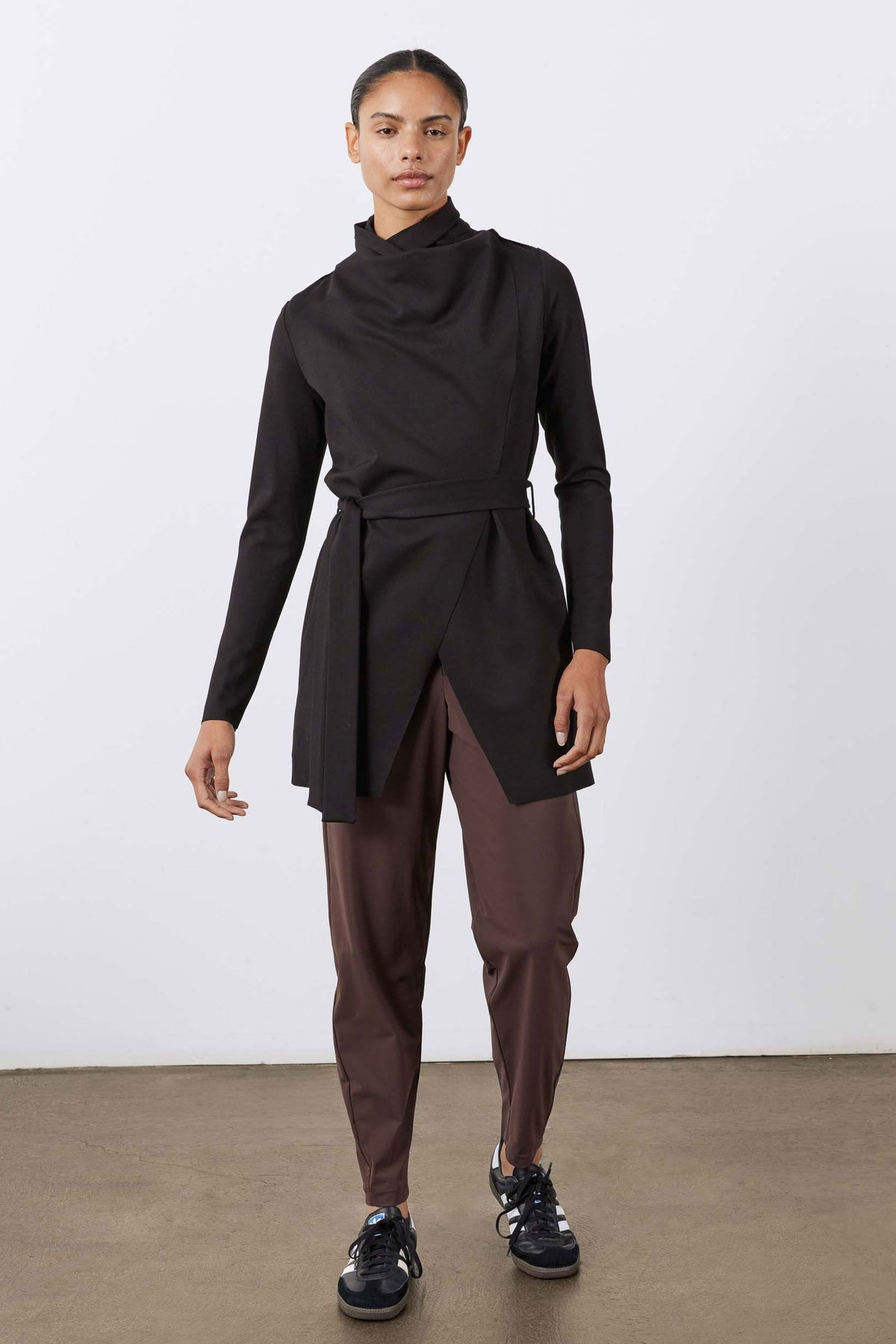 Black draped jacket with waist belt and high collar, open front detail