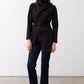 Black belted jacket with high collar and long sleeves, front drape detail.