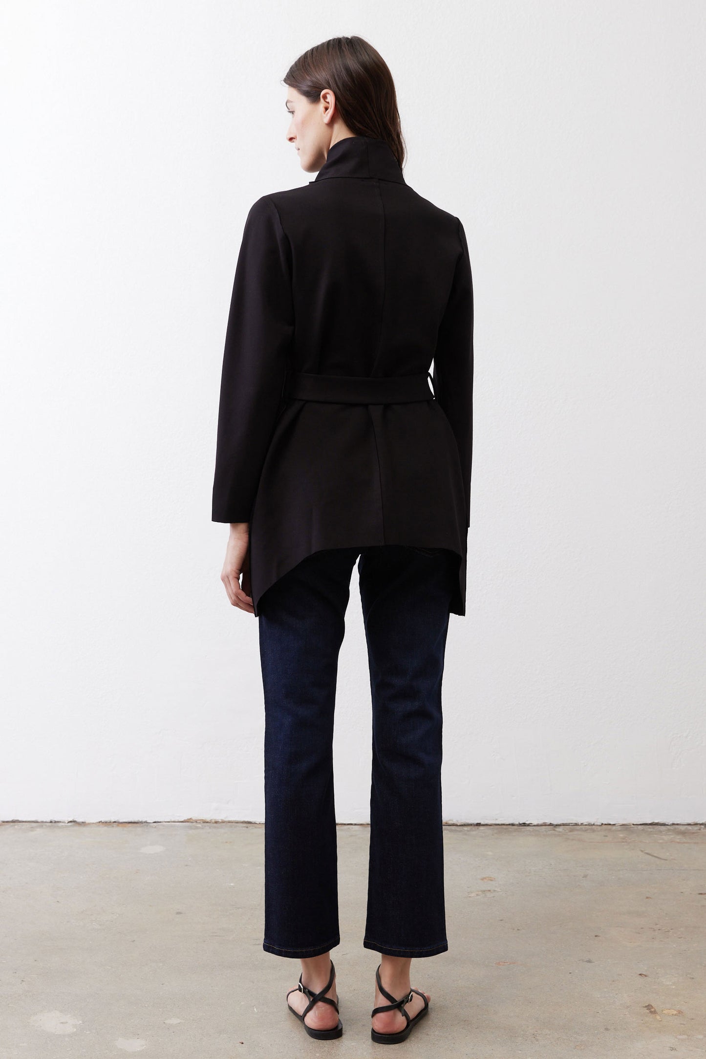 Black jacket with belted waist and clean back silhouette