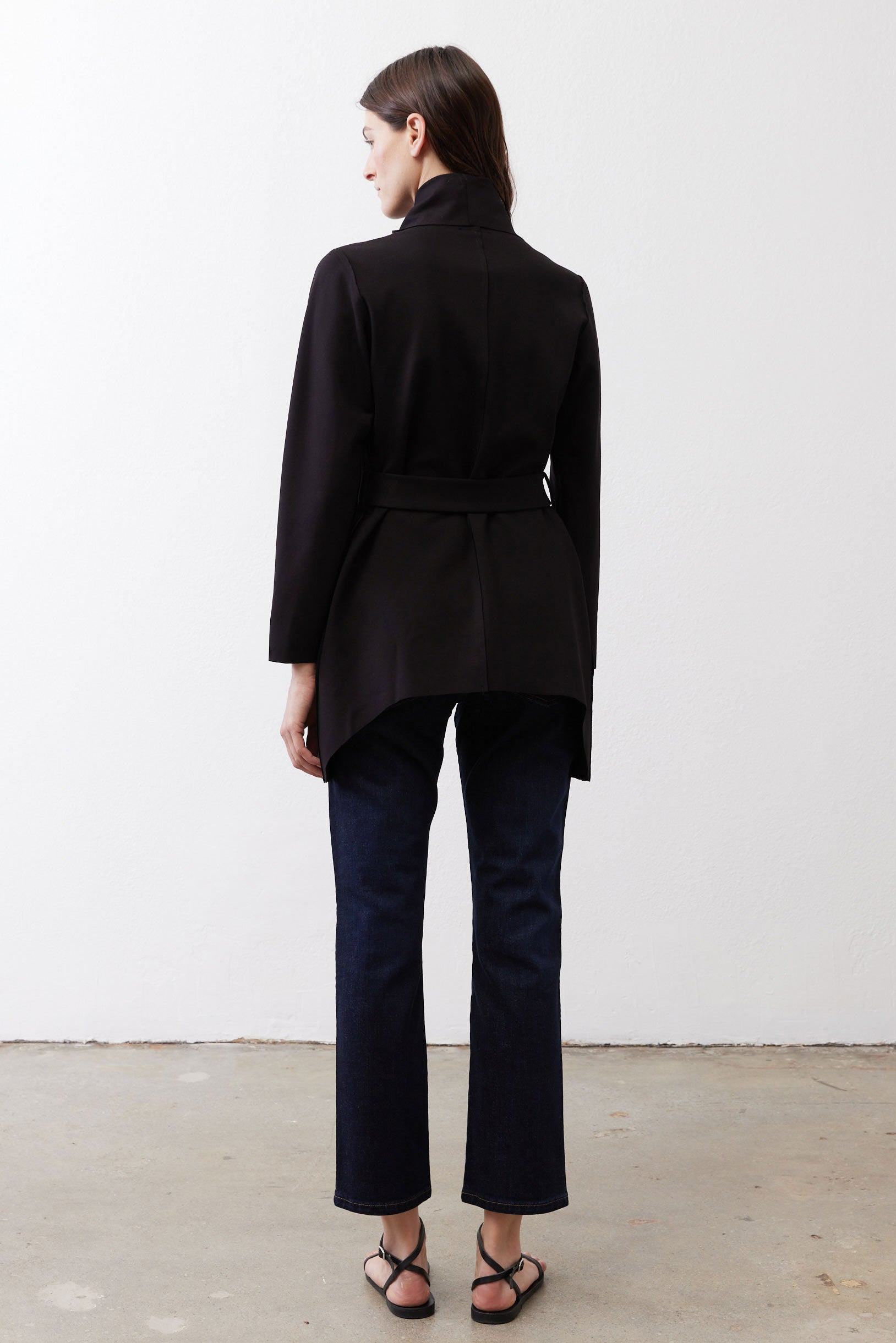 Black jacket with belted waist and clean back silhouette