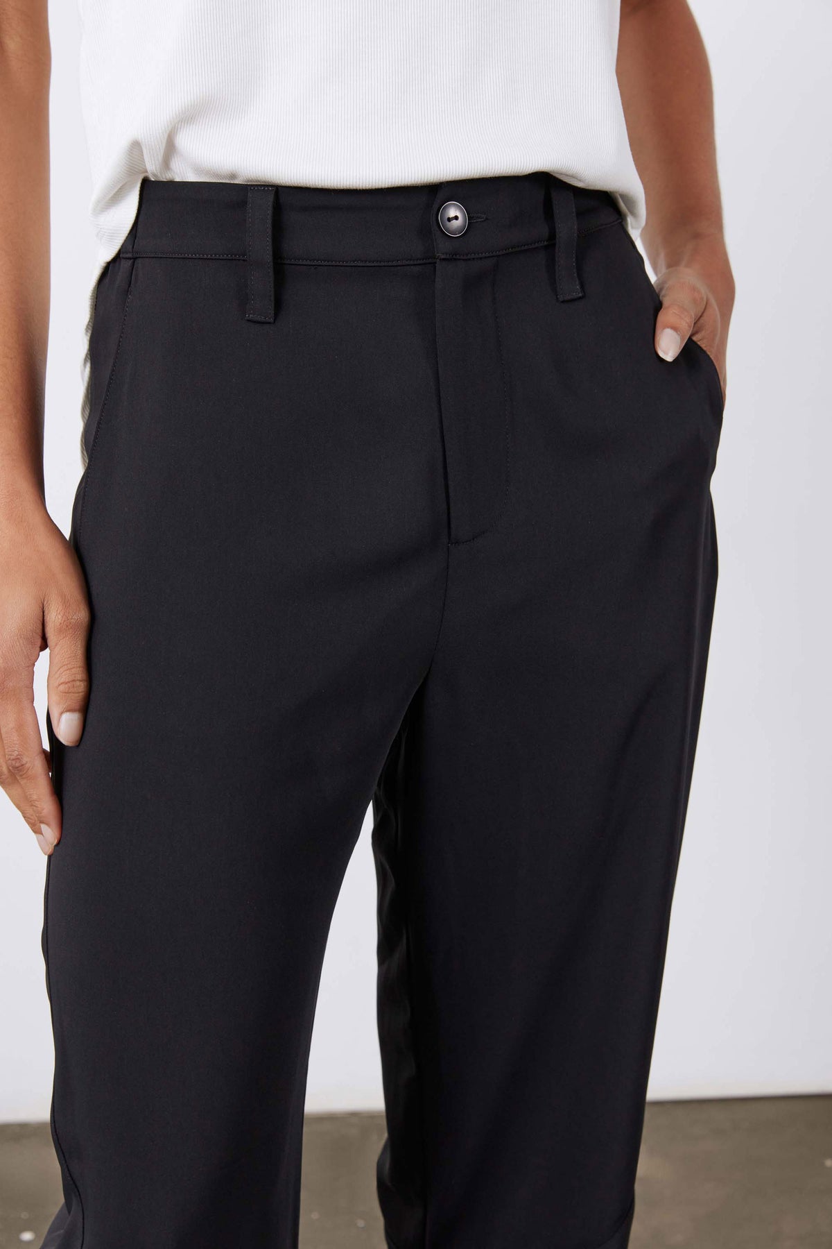 Black formal pants with button closure, belt loops, and angled side pockets