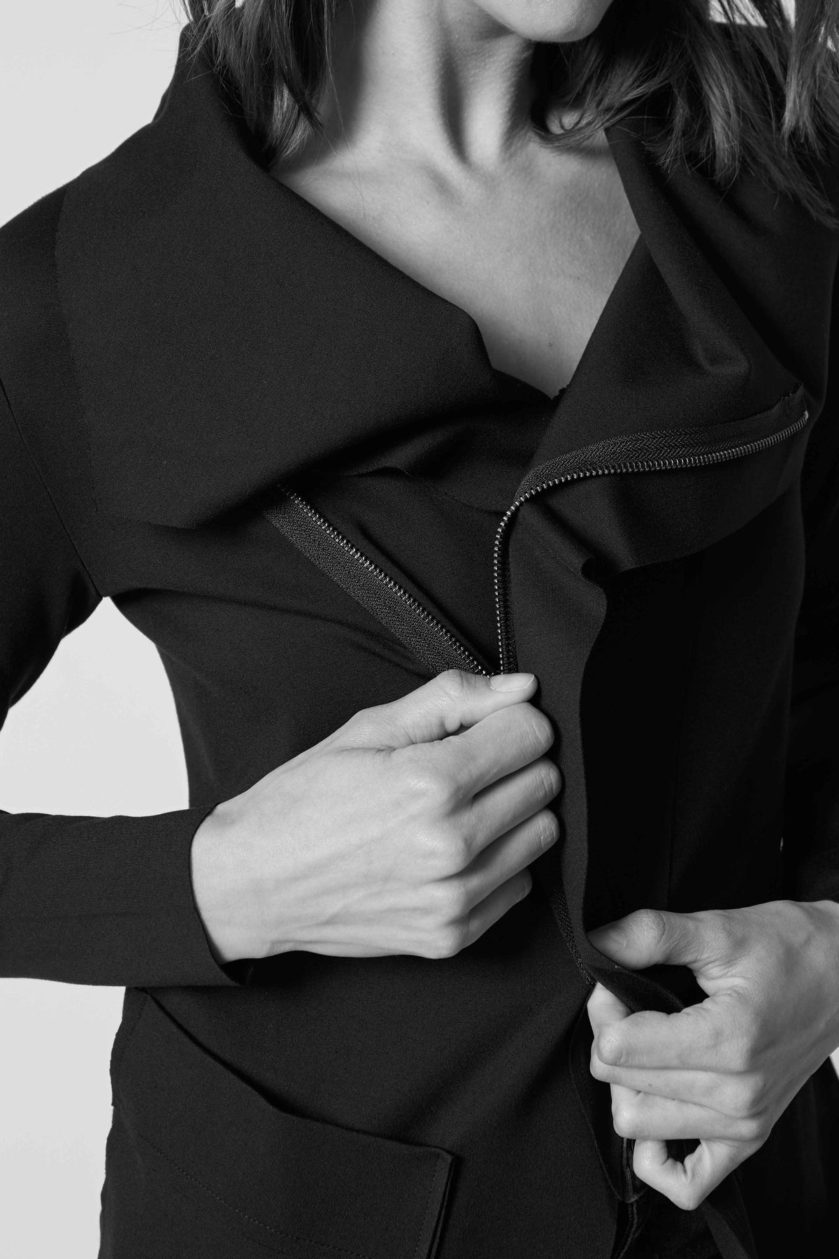 Black jacket with asymmetrical collar and front zipper, patch pockets