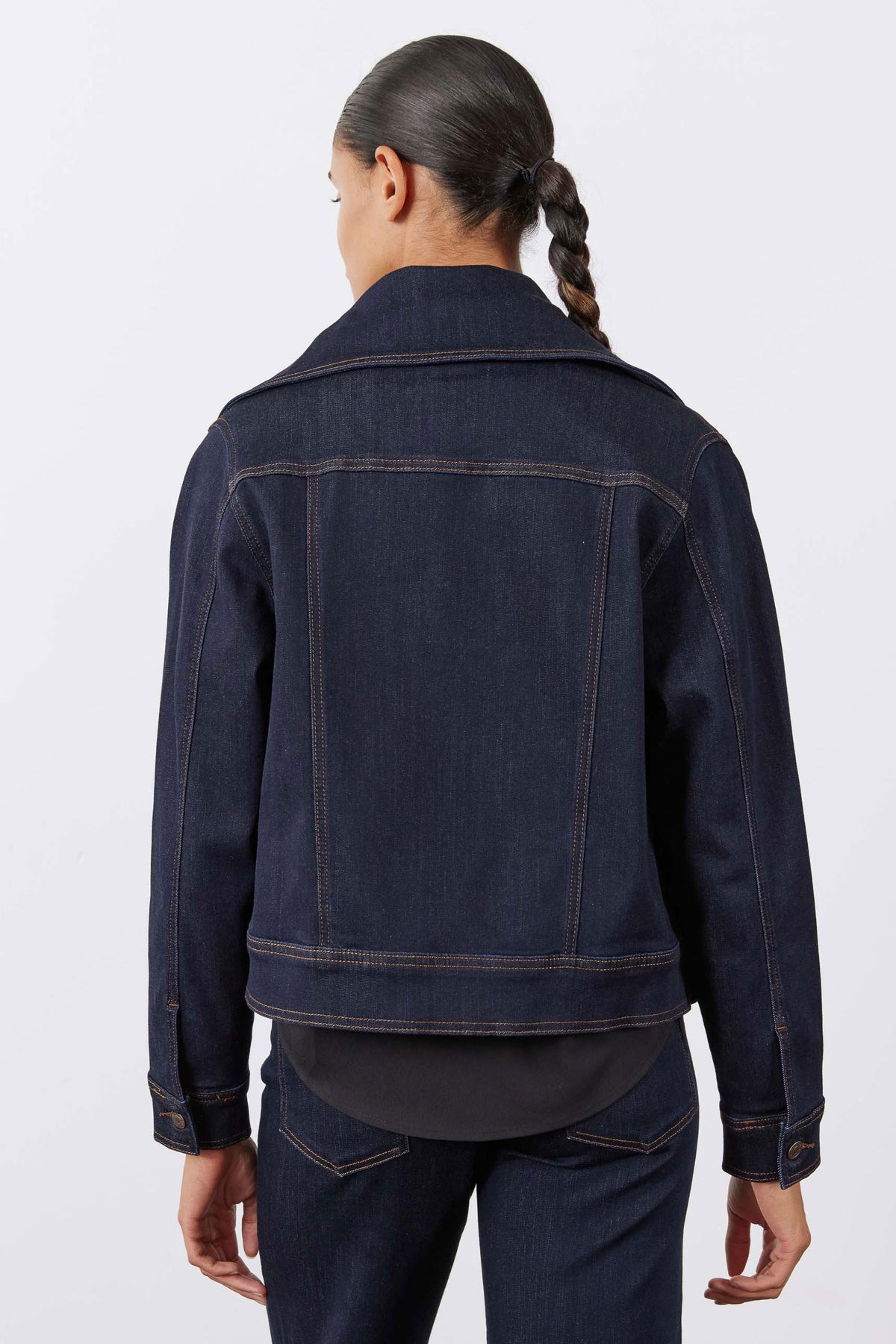 Dark denim jacket back with yoke seam and contrasting topstitching