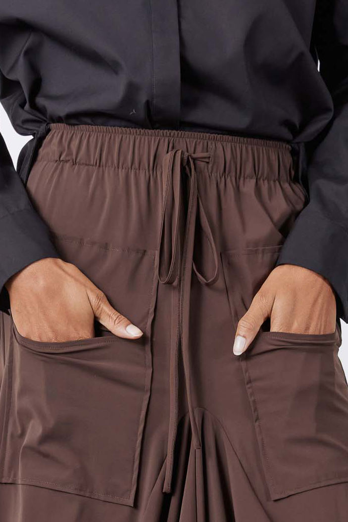Close-up of coffee-brown skirt waistband with drawstring and front patch pockets