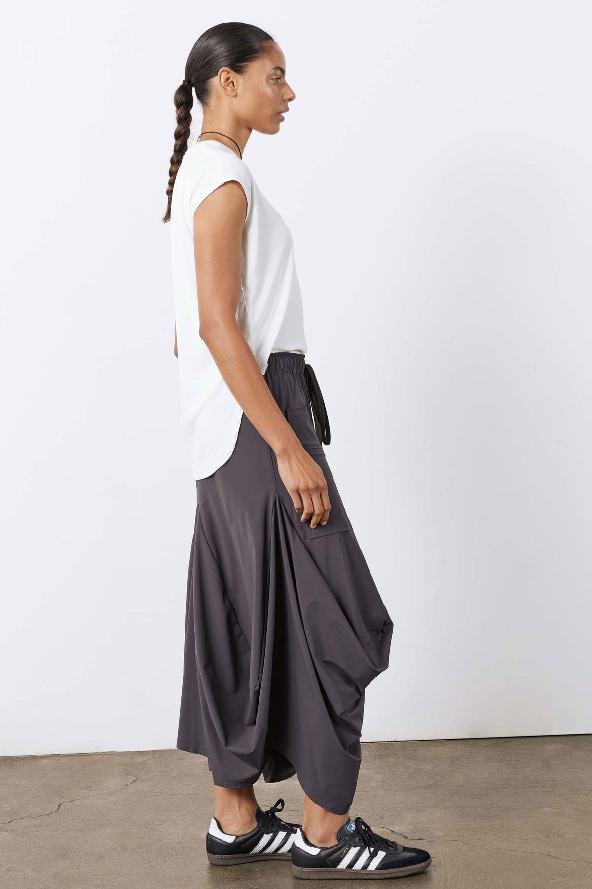 Graphite draped midi skirt with elastic waist, cargo pockets, and gathered front fold