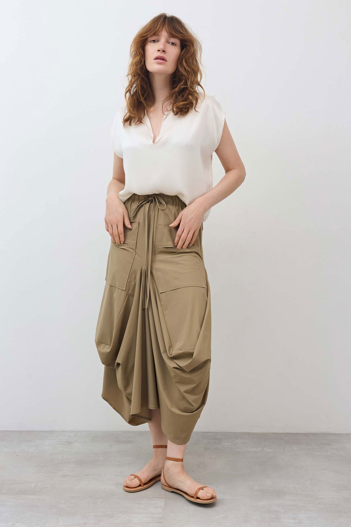 Dune utility midi skirt with elastic waist, drawstring tie, cargo pockets, draped sides