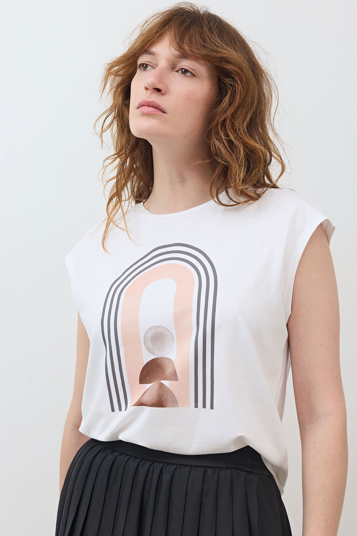 White sleeveless graphic tee showing centered rainbow arch design