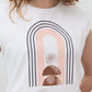 White sleeveless graphic tee with large rainbow arch graphic on the chest