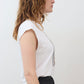 White sleeveless tee with crew neck, worn to the side