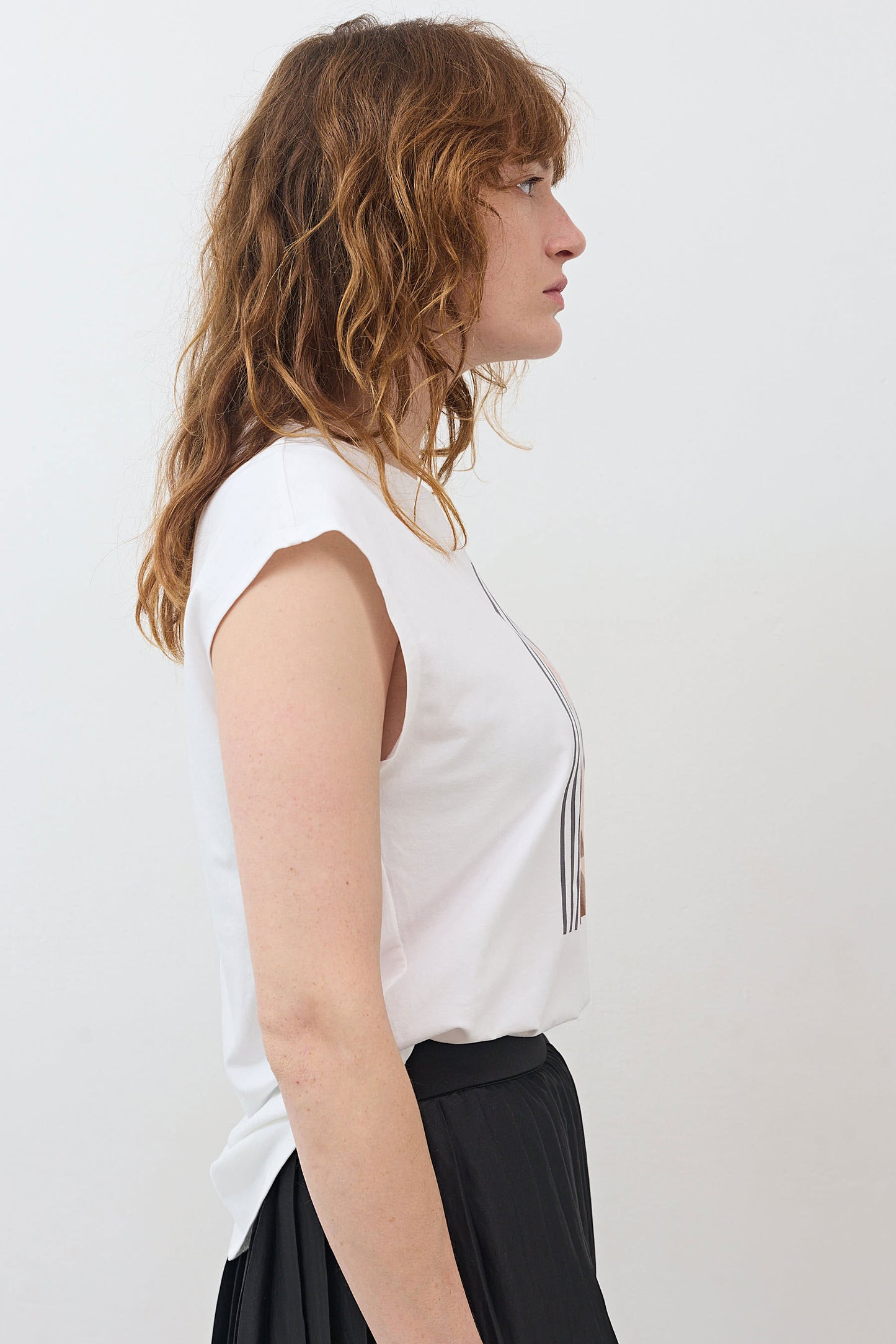 White sleeveless tee with crew neck, worn to the side