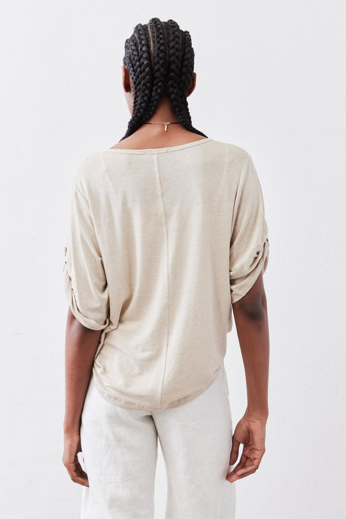 Oat half-button top from behind with elbow sleeves and rounded back hem