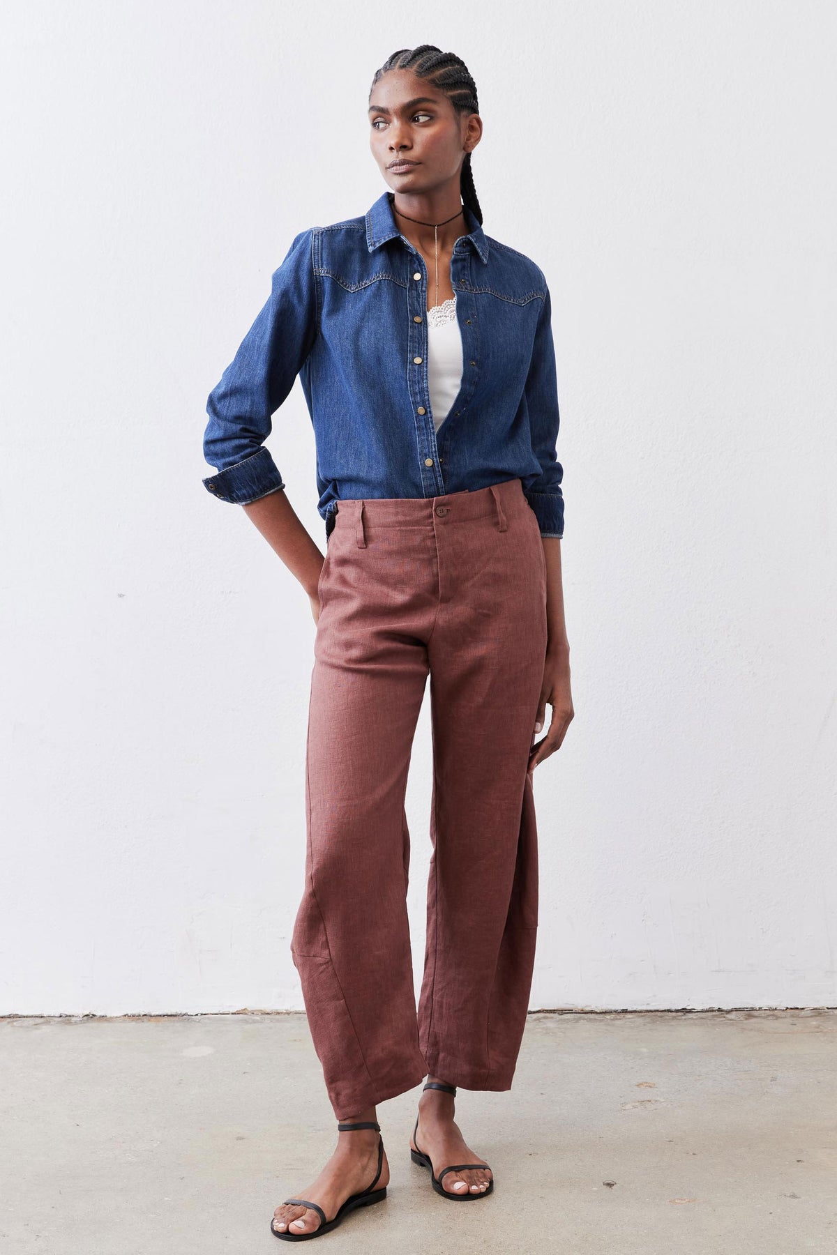 Medium-wash denim button-up shirt with long sleeves and front button closures