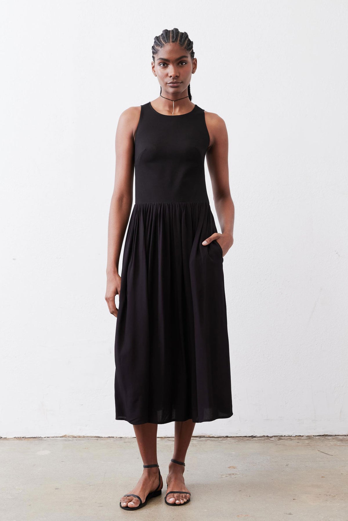 Black high-neck tank dress with gathered skirt, sleeveless midi, full body