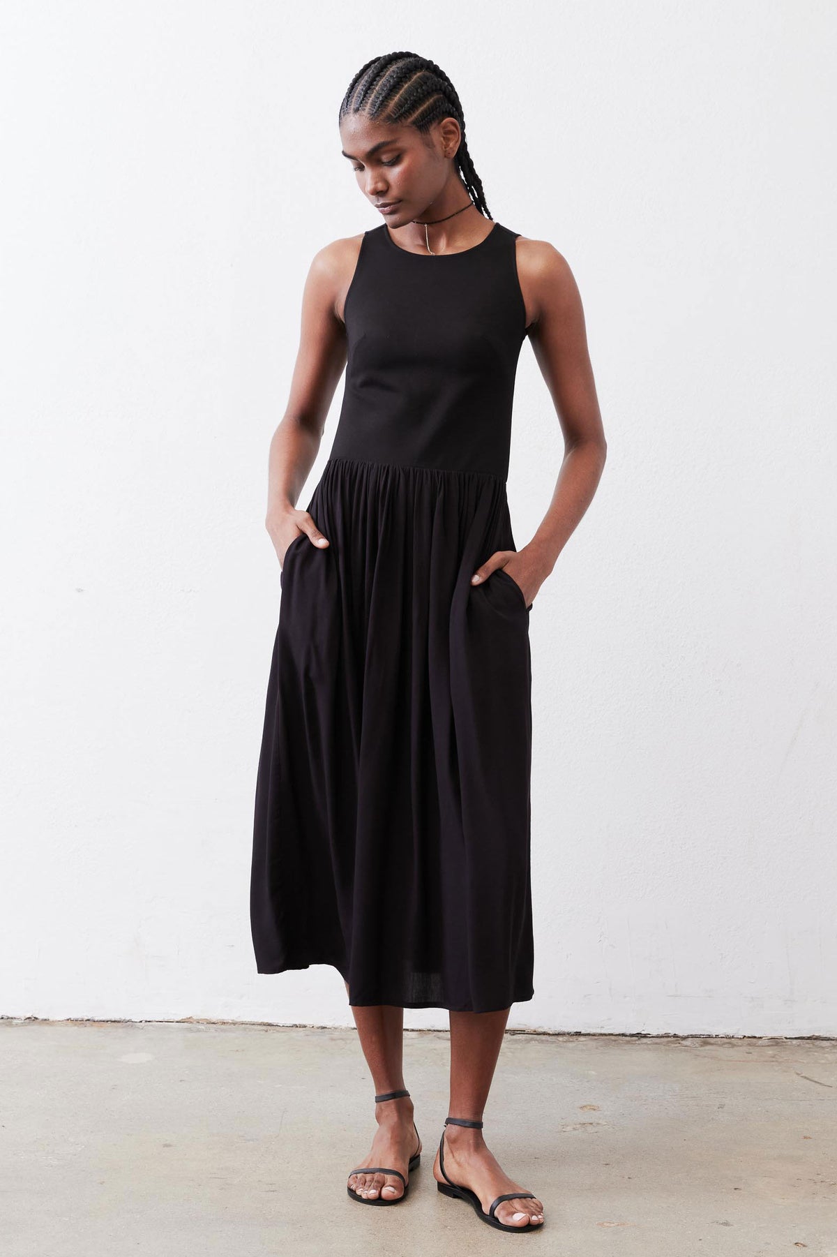 Black high-neck tank dress with gathered skirt, sleeveless midi